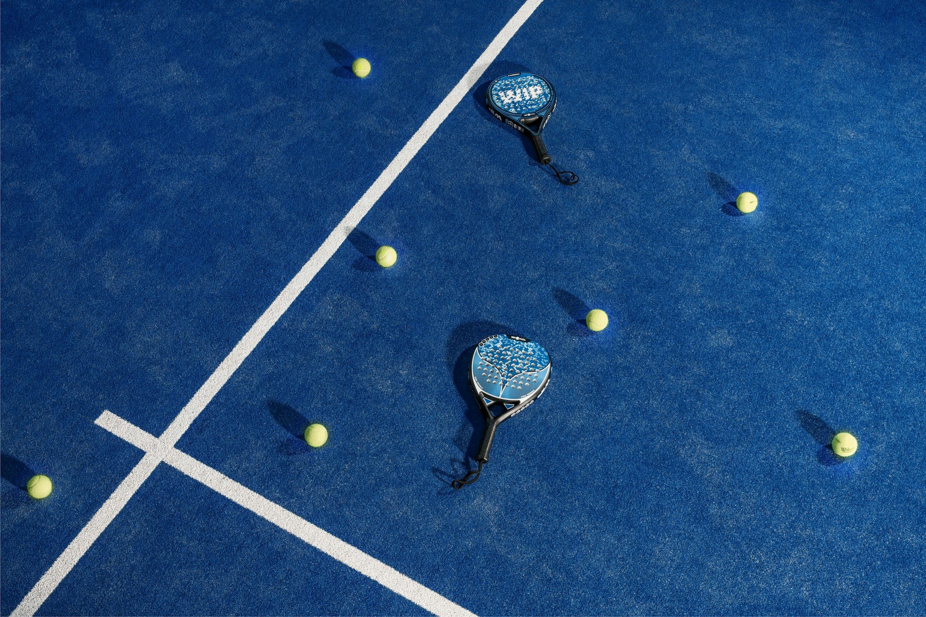 Padel racket and ball on the court, ready to play